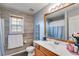 Bathroom featuring decorative wood-look tiling, wide window with natural light, and modern fixtures at 5069 Luxford Dr, Douglasville, GA 30135