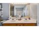 Bathroom with double sinks, modern vanity, and wood-look tile accents at 5069 Luxford Dr, Douglasville, GA 30135