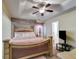 Bedroom featuring tray ceilings, and an impressive bed, creating a luxurious and relaxing ambiance at 5069 Luxford Dr, Douglasville, GA 30135