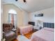 Cozy bedroom with two twin beds, accent chair, and a charming arched window providing natural light at 5069 Luxford Dr, Douglasville, GA 30135