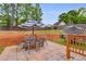 Back patio with an outdoor dining set, umbrellas and tiered landscaping at 5069 Luxford Dr, Douglasville, GA 30135