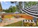 Back patio with dining set, seating, and tiered wood retaining wall at 5069 Luxford Dr, Douglasville, GA 30135