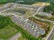 An aerial view of a well-planned community with manicured lawns, walking trails, and a serene pond at 52 Lantern Trce, Hiram, GA 30141