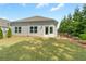 This cozy backyard features a well-maintained lawn and a lovely patio with a door leading indoors at 52 Lantern Trce, Hiram, GA 30141
