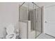 Bright bathroom with a large glass enclosed shower, toilet, and modern fixtures at 52 Lantern Trce, Hiram, GA 30141
