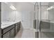 Stylish bathroom featuring double vanity with stone countertop, glass shower enclosure, and modern fixtures at 52 Lantern Trce, Hiram, GA 30141