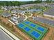 Aerial view of community amenities including pond, clubhouse, tennis courts and pickleball courts at 52 Lantern Trce, Hiram, GA 30141