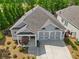 View of home featuring a two-car garage, covered porch, and well-maintained landscaping at 52 Lantern Trce, Hiram, GA 30141
