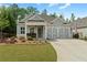 Charming one-story home with manicured lawn and cozy front porch seating at 52 Lantern Trce, Hiram, GA 30141