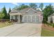 Charming one-story home with manicured lawn and cozy front porch seating at 52 Lantern Trce, Hiram, GA 30141