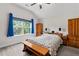 Comfortable main bedroom boasts a large window, bench and natural light creating a relaxing retreat at 52 Lantern Trce, Hiram, GA 30141