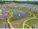 A serene pond with a fountain is surrounded by a walking path and lush greenery at 52 Lantern Trce, Hiram, GA 30141