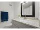 Bathroom with modern vanity, granite countertop, and large mirror at 5626 River Heights Se Xing, Marietta, GA 30067