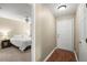 View of the bedroom with neutral walls and white bedding, visible from the hallway at 5626 River Heights Se Xing, Marietta, GA 30067