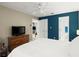 Bedroom featuring tv and white bedding, with closet and bathroom nearby at 5626 River Heights Se Xing, Marietta, GA 30067