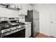 Updated kitchen featuring a gas stove, stainless steel appliances, and plenty of cabinet space at 5626 River Heights Se Xing, Marietta, GA 30067