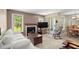 Comfortable living room with fireplace, plush white sofa, and bright windows at 5626 River Heights Se Xing, Marietta, GA 30067