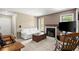 Inviting living room featuring a white sofa, fireplace, and neutral carpet at 5626 River Heights Se Xing, Marietta, GA 30067