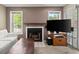 Bright living room with a fireplace, TV, and sliding glass doors at 5626 River Heights Se Xing, Marietta, GA 30067