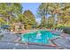 Sparkling community pool surrounded by lounge chairs and lush landscaping, offering a relaxing outdoor space at 5626 River Heights Se Xing, Marietta, GA 30067