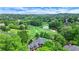 Stunning aerial view of a home on a golf course with lush green fairways and mature trees at 6515 Ashbourne Ct, Suwanee, GA 30024