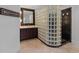 Modern bathroom featuring a glass block shower, marble floors, and stylish vanity at 6515 Ashbourne Ct, Suwanee, GA 30024