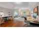 Spacious bedroom with hardwood floors, desk area, and ambient lighting fixtures at 6515 Ashbourne Ct, Suwanee, GA 30024