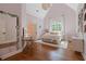 Bright bedroom boasts a vaulted ceiling, hardwood floors, and a large window at 6515 Ashbourne Ct, Suwanee, GA 30024