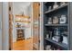 Walk through butler's pantry with custom shelving, built in refrigerator and marble countertops at 6515 Ashbourne Ct, Suwanee, GA 30024