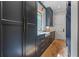 Butler's pantry with dark cabinets, stainless steel appliances, diamond windows, and brick floor tiles at 6515 Ashbourne Ct, Suwanee, GA 30024