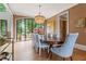 Beautiful dining room featuring hardwood floors, large windows, and stylish chandelier at 6515 Ashbourne Ct, Suwanee, GA 30024
