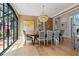 Elegant dining room featuring a large window, chandelier, artwork, and table with seating for six at 6515 Ashbourne Ct, Suwanee, GA 30024