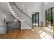 Elegant foyer showcasing a curved staircase with iron railings and hardwood floors at 6515 Ashbourne Ct, Suwanee, GA 30024