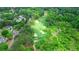 An aerial view of a golf course surrounded by homes and natural beauty, with a small river at 6515 Ashbourne Ct, Suwanee, GA 30024