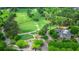 A beautiful aerial view of a lush green golf course with mature trees and an elegant clubhouse at 6515 Ashbourne Ct, Suwanee, GA 30024