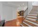 Inviting hallway with hardwood floors leading to a staircase and cozy living area at 6515 Ashbourne Ct, Suwanee, GA 30024