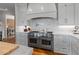Gourmet kitchen with stainless steel appliances, a herringbone backsplash, and marble countertops at 6515 Ashbourne Ct, Suwanee, GA 30024