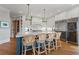 Spacious kitchen with an island, white cabinetry, stainless steel appliances, and bar stool seating at 6515 Ashbourne Ct, Suwanee, GA 30024
