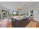 Bright kitchen with a center island, stainless steel appliances, hardwood floors, and easy access to the backyard at 6515 Ashbourne Ct, Suwanee, GA 30024