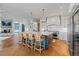 Open-concept kitchen with a large island, stainless steel appliances, hardwood floors, and a cozy fireplace at 6515 Ashbourne Ct, Suwanee, GA 30024