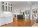 Spacious kitchen with white cabinets, stainless steel appliances, large island, and beautiful hardwood floors at 6515 Ashbourne Ct, Suwanee, GA 30024