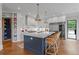 Gourmet kitchen with a large center island, marble countertops, stainless appliances, and ample storage at 6515 Ashbourne Ct, Suwanee, GA 30024