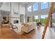 Stunning living room with large windows, a fireplace, and elegant decor at 6515 Ashbourne Ct, Suwanee, GA 30024