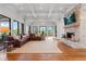 Expansive living room with stone fireplace, hardwood floors, and access to patio at 6515 Ashbourne Ct, Suwanee, GA 30024
