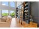 Library with tall windows, a rolling ladder, and hardwood floors at 6515 Ashbourne Ct, Suwanee, GA 30024