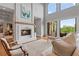 Inviting living room with a fireplace, large windows, and comfortable seating at 6515 Ashbourne Ct, Suwanee, GA 30024