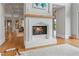 Cozy living room featuring fireplace, hardwood floors and open floor plan at 6515 Ashbourne Ct, Suwanee, GA 30024
