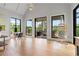 Bright living room with vaulted ceilings, hardwood floors, and access to an outdoor patio with a hanging chair at 6515 Ashbourne Ct, Suwanee, GA 30024