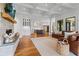 Open concept living room with stone fireplace and connecting kitchen area at 6515 Ashbourne Ct, Suwanee, GA 30024