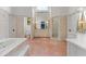 Open layout main bathroom with marble floors, double vanity, shower, soaking tub, and water closet at 6515 Ashbourne Ct, Suwanee, GA 30024